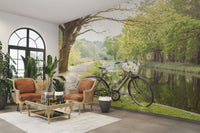 Canal path wallpaper with green forest backdrop

