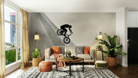 Freestyle biker riding up wall slope

