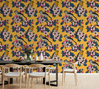Classic bird wallpaper with blossoms over a warm mustard yellow base