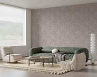 Lounge seating area styled with Bloomscape Beige Wallpaper and low green sofa