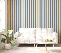 Blue and Yellow Candy Stripes Wallpaper behind a white sofa in a bright living room
