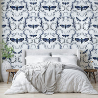 Midnight blue wallpaper with illustrated moths and curling vines.


