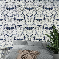 Moody gothic wallpaper showing moths over dark botanical swirls.

