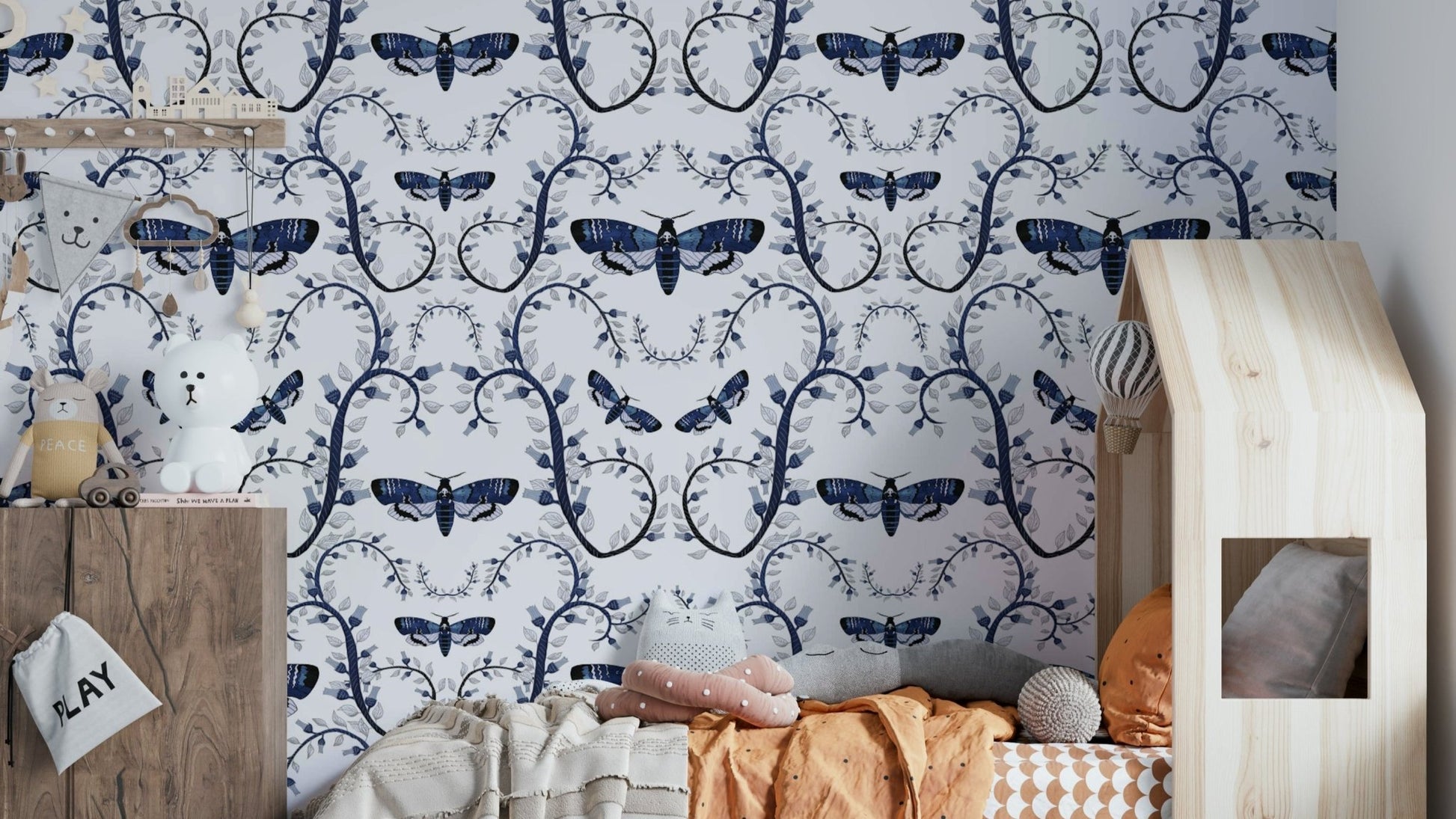 Dramatic interior wallpaper with gothic insects and twisting stems.

