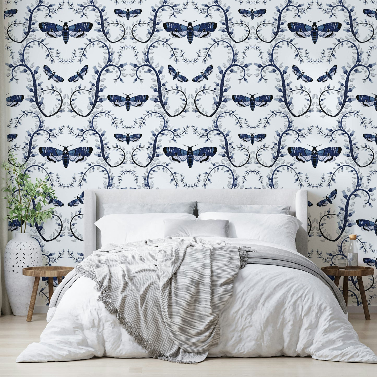 Midnight blue wallpaper with illustrated moths and curling vines.

