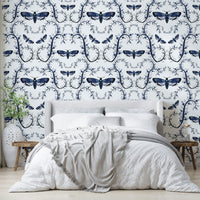 Midnight blue wallpaper with illustrated moths and curling vines.

