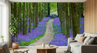 Charming nature wallcovering, long path through bluebell carpet.