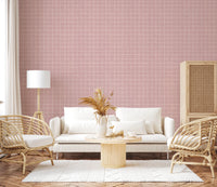Blush pink textured grid wallpaper with woven effect.