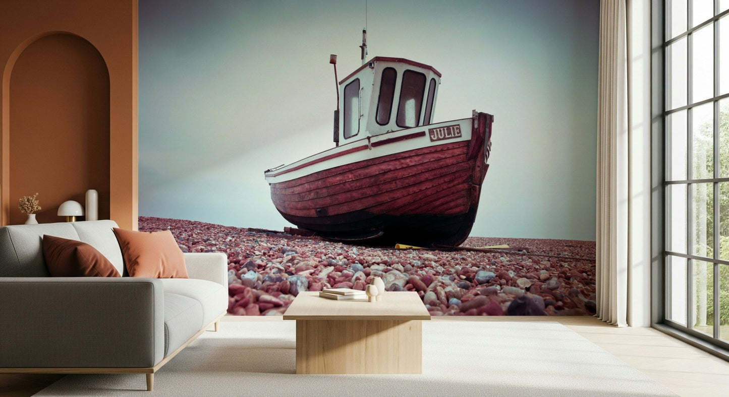 Rustic Boat Resting on Pebbled Strand wall mural for coastal decor.