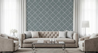 Minimal living room framed with calming blue trellis wallpaper and airy arrangement