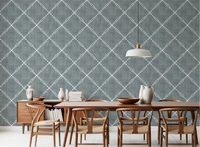 Dining room styled with calming blue dotted trellis wallpaper and wooden table setting
