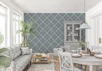 Bright dining space paired with calming blue dotted trellis wallpaper and neutral tones