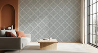 Soft bedroom interior featuring grey trellis wallpaper with subtle textured pattern
