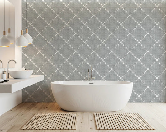 Modern bathroom styled with grey dotted trellis wallpaper and freestanding bathtub