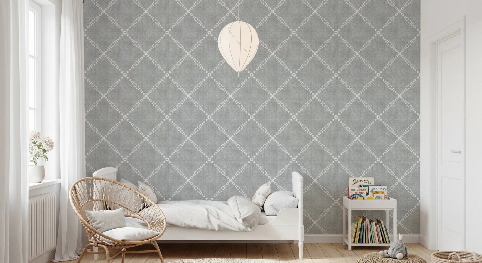 Kids bedroom corner styled using grey trellis wallpaper with soft patterned walls