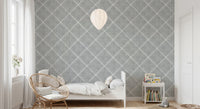 Kids bedroom corner styled using grey trellis wallpaper with soft patterned walls