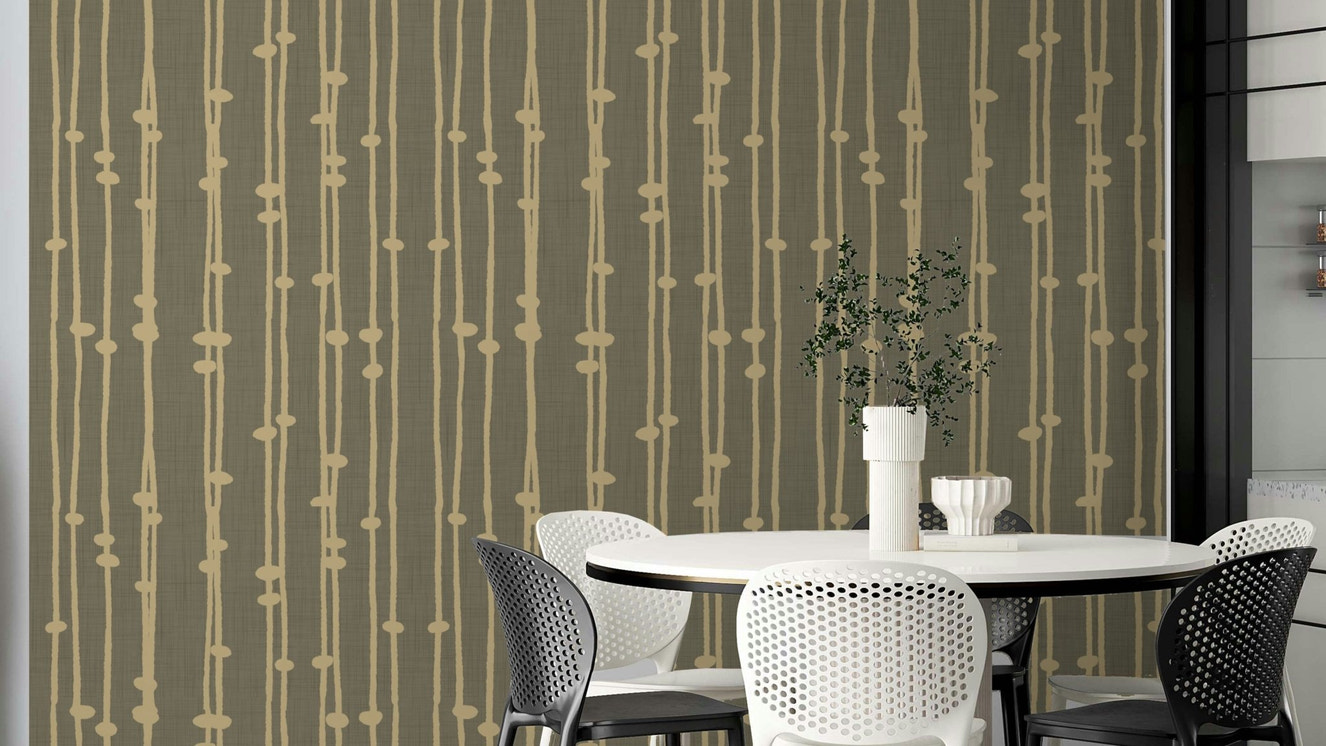 The wallpaper is used to create a feature wall in a dining room.