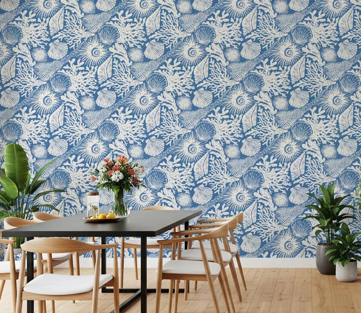 White marine sketches sit behind a Dining room with Boho Seashell Coral wallpaper.⁠GD9548
