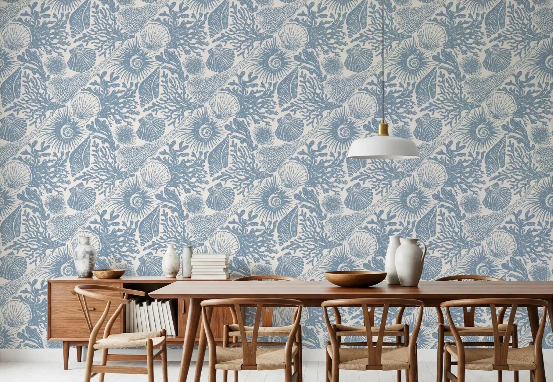 A dining room sits softly under Boho Seashell Coral wallpaper in muted blue tones.⁠GD9545