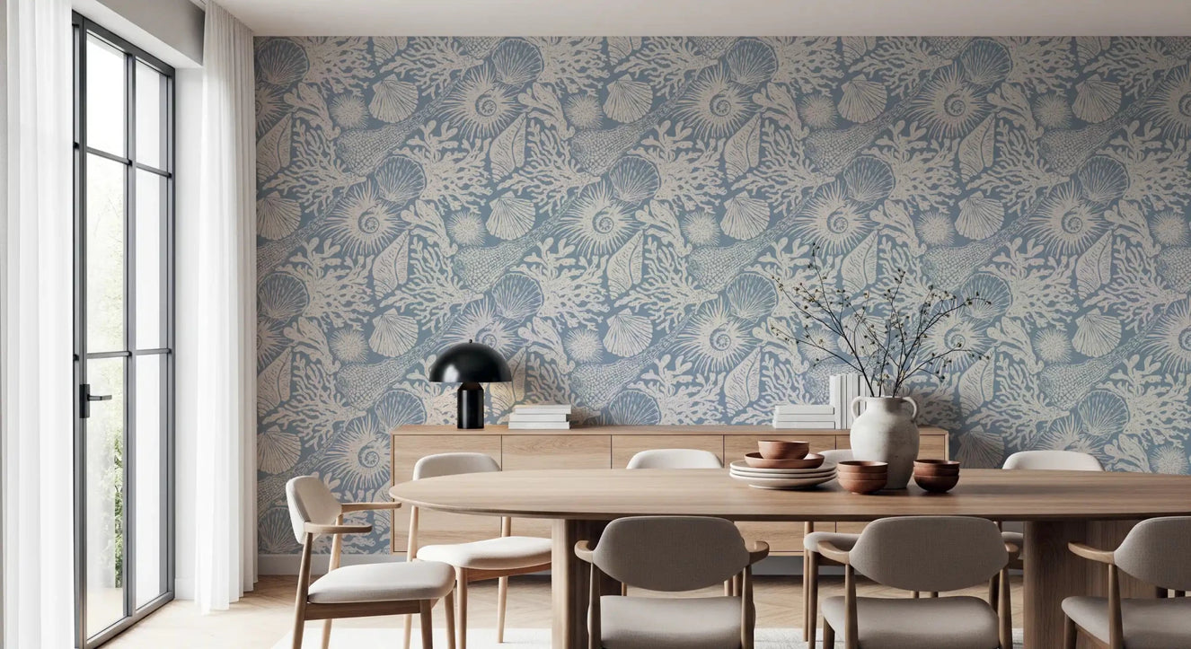 Soft azure tones wash a dining room with Seashell Coral Azure wallpaper.⁠GD9547