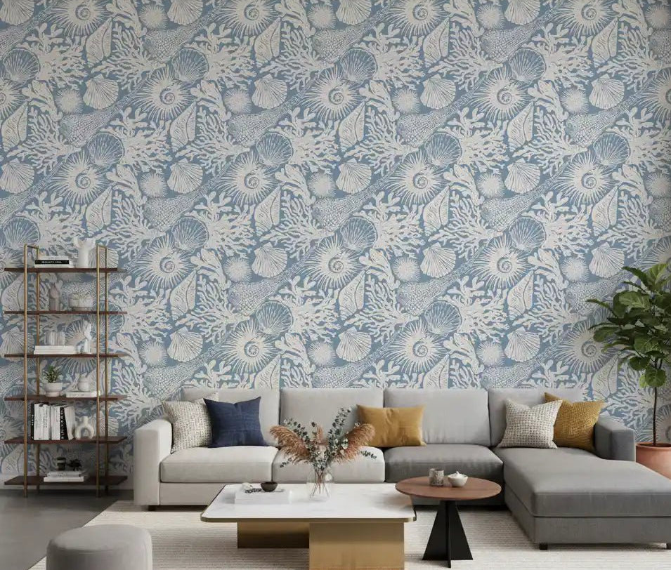 Off-white marine sketches sit behind a living room with Boho Seashell Coral wallpaper.⁠GD9547