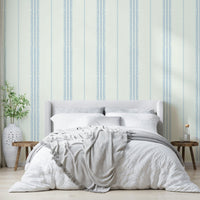 Linen-textured wallpaper with light blue boho stripes.

