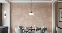 Soft botanical wall mural with cream leaves on a warm blush background