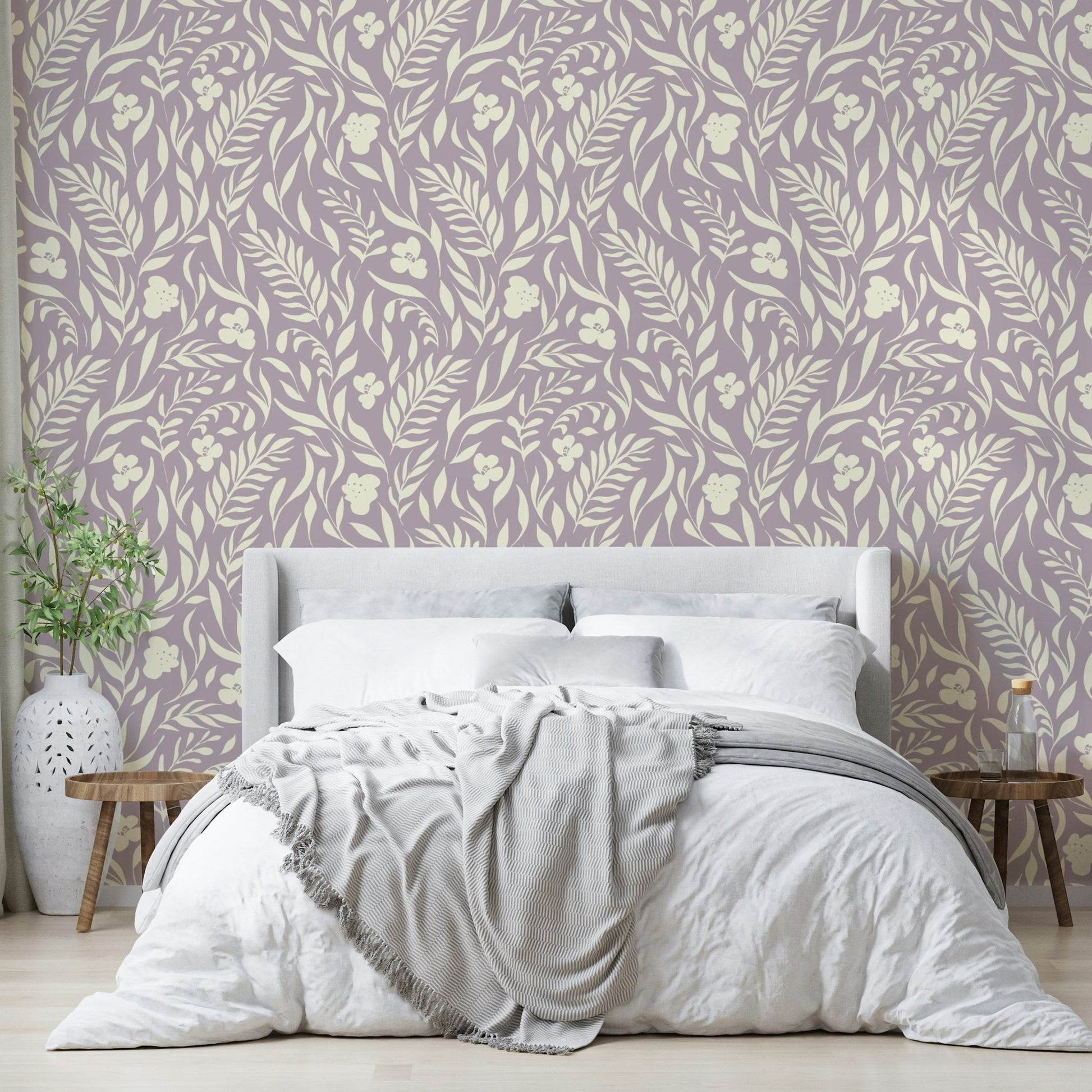 A bedroom decorated with a botanical wallpaper

