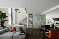 Living room accent with nature-inspired wallpaper

