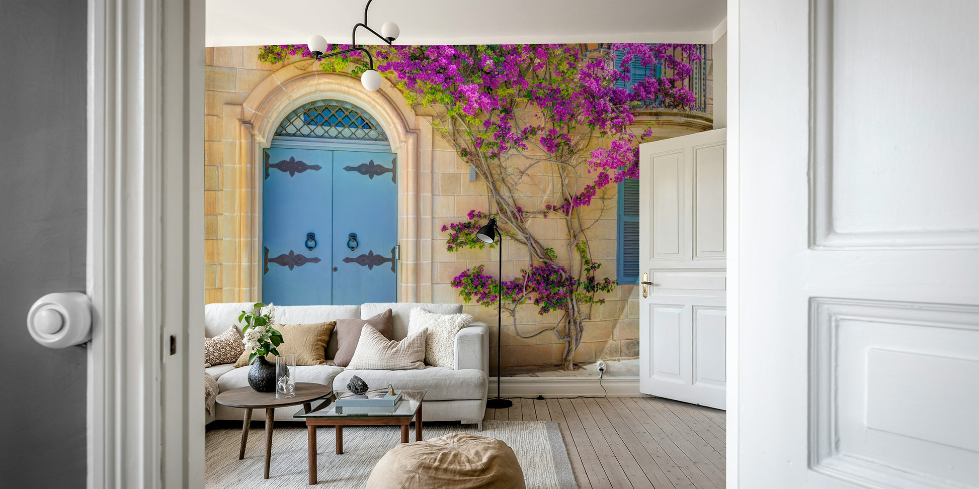 The door is framed by a cascade of vibrant bougainvillea flowers.

