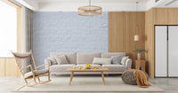 Bright lounge space with Brick Decor Wall Mural behind a low sofa and side table