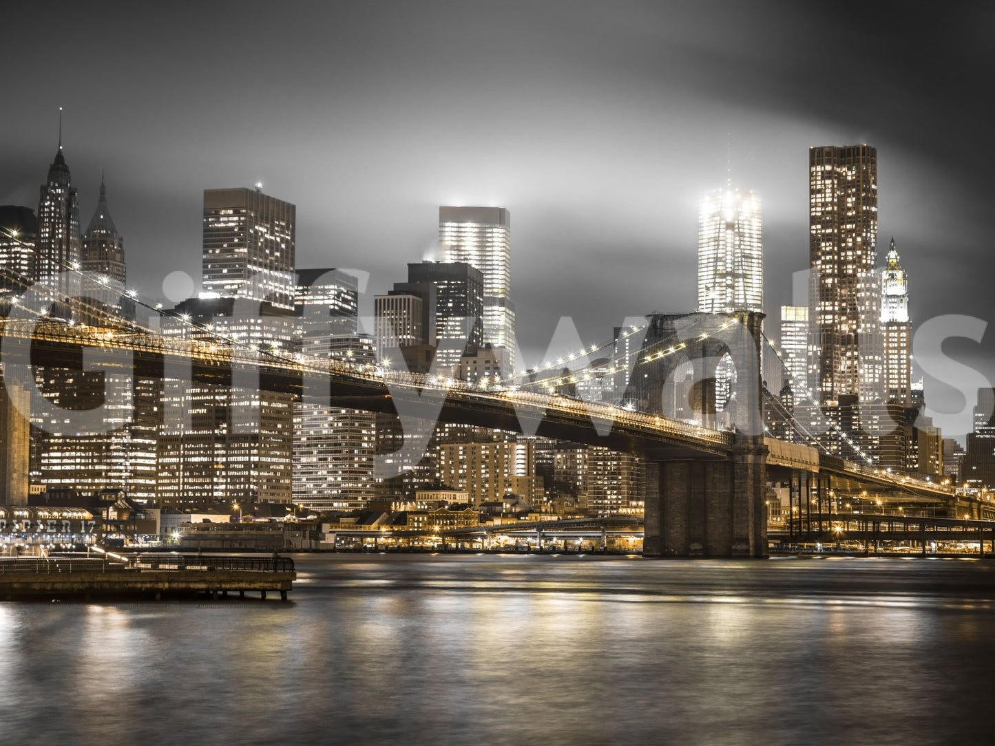 Brooklyn Bridge illuminated in a cityscape at night

