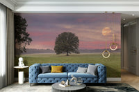 A peaceful tree and field mural on decorative wallpaper.

