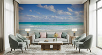 Full living room featuring the bright, expansive Cancun Beach mural behind a cream sofa.