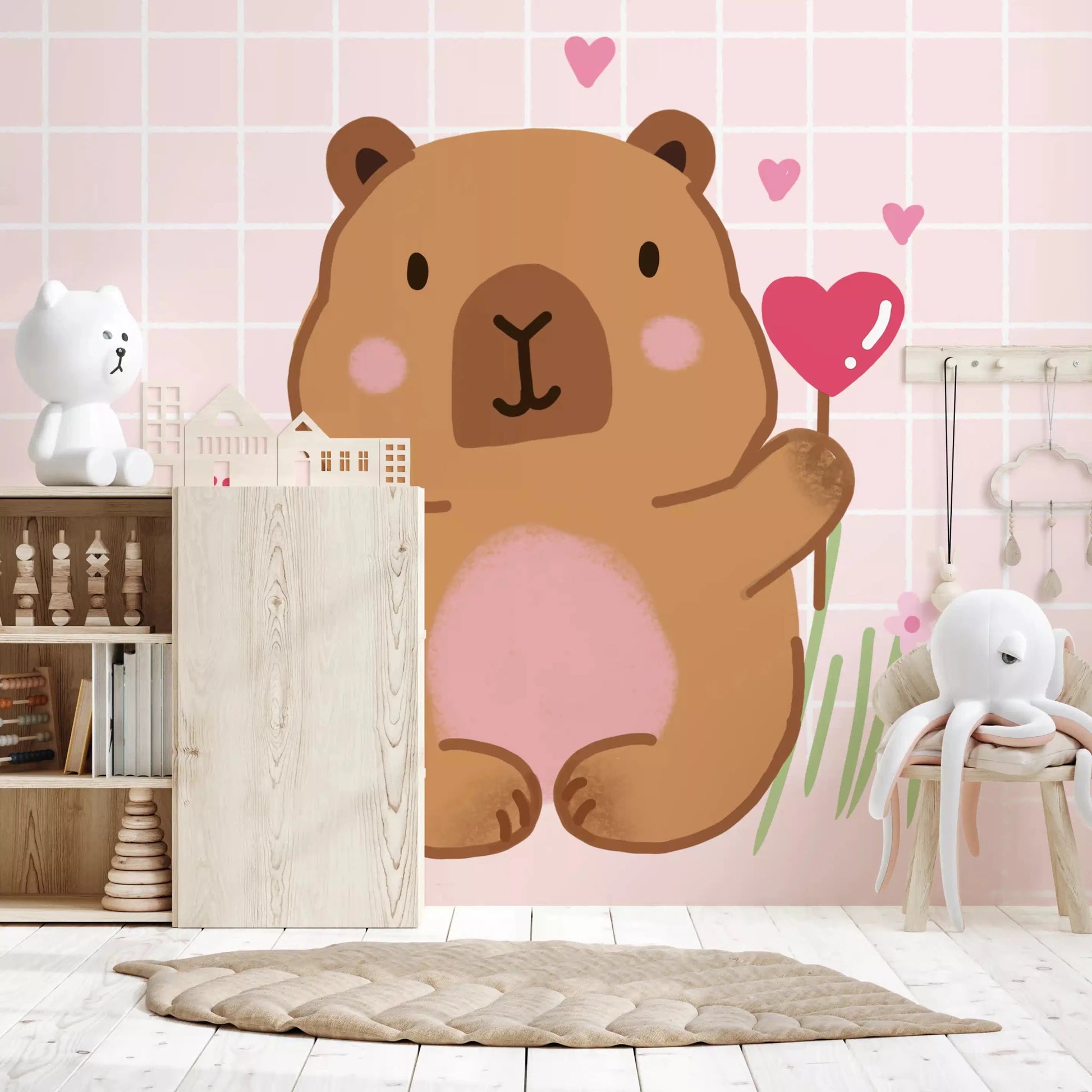 Pink grid backdrop behind the Capybara wall muralGD9447