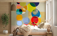 Along the bedroom, Chromatic Circles wall mural creates a bold visual rhythm