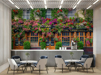 Vibrant flowers and greenery framing a traditional pub exterior

