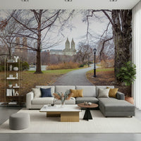 Minimalist apartment lounge with a skyscraper and tree landscape wallpaper.