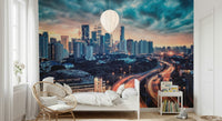 Framed beside a bright window, Cityscape Dawn Wall Mural brings city depth indoors