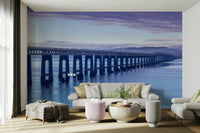 A peaceful wall mural with a panoramic view of a coastline.

