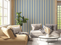 Sunlit living room layered with Coastal Stripes Wallpaper in blue and beige bands