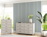 lounge corner setting softened by Coastal Stripes Wallpaper in blue beige tones