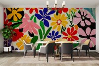 Whimsical wall mural with cut-out flowers in bright hues

