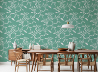 Dining room styled with Cozy Scandi Folk Leaf Vine Sage Mint wallpaper and wood seating, GD8544