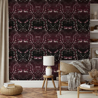 Bold red wallpaper with hand-drawn moths in motion.

