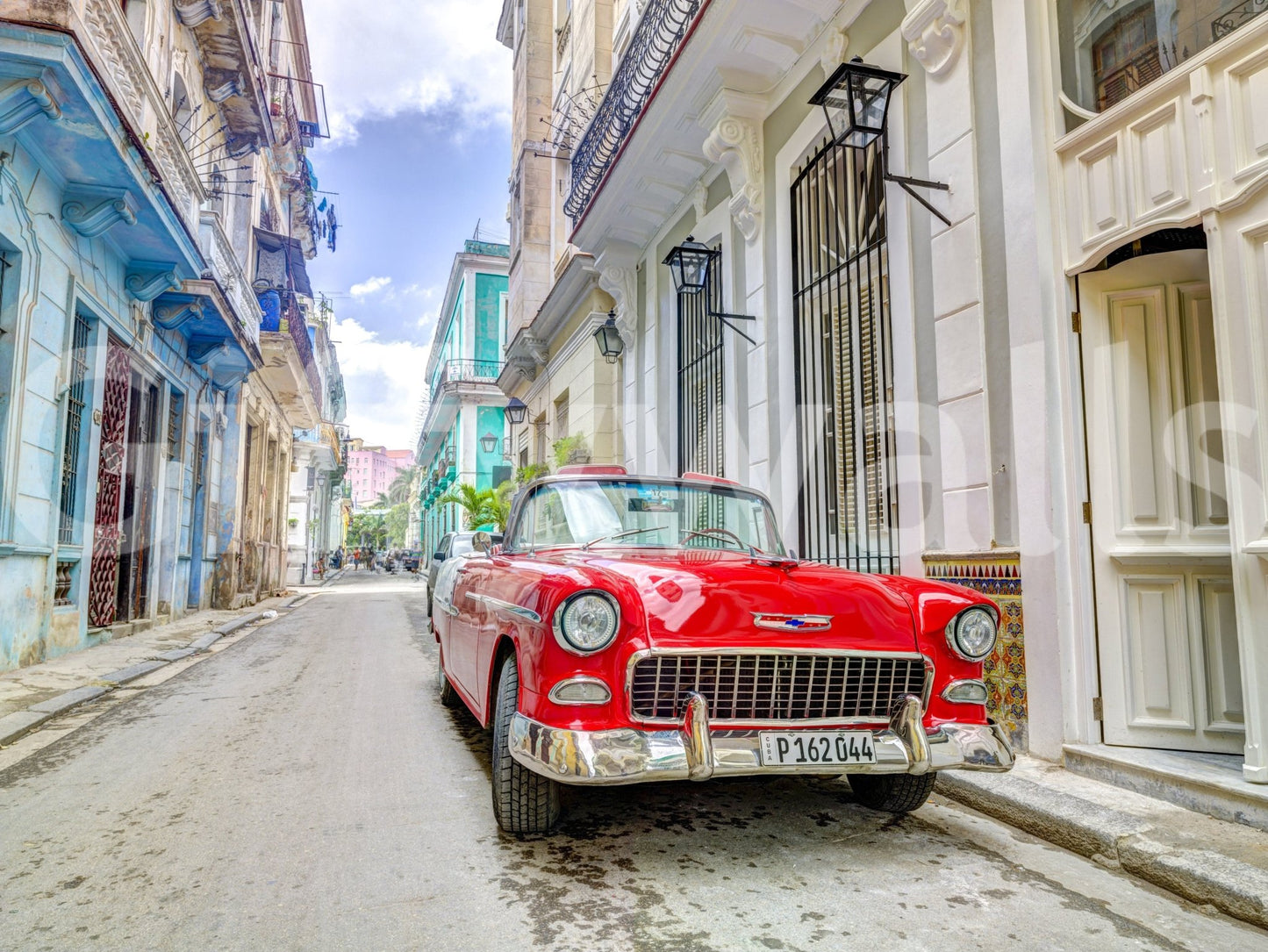Sun-drenched building facade wall mural for a guest room.