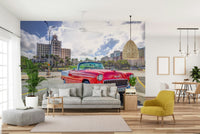 The street is lined with classic Cuban buildings.

