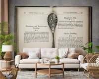 Ornate silver spoon on Culinary Antiques wallpaper mural background.