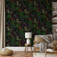 Mural of leaves and vines on a dark background.
