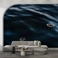 Bedroom accent wall featuring blue wave mural.